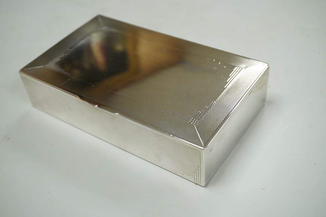 A George VI engine turned silver mounted rectangular cigarette box, by John Rose, Birmingham, 1936, 14.2cm.